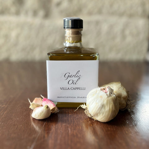 A bottle of Villa Cappelli Garlic Oil sitting on a table.