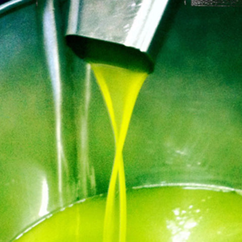 A bottle of Villa Cappelli Organic 3L Extra Virgin Olive Oil is being poured into a metal pot.