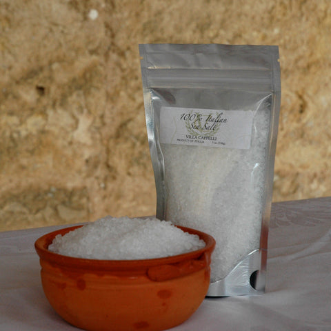 A bag of the Grazie! Thank you! Collection sea salt sitting next to a bowl.