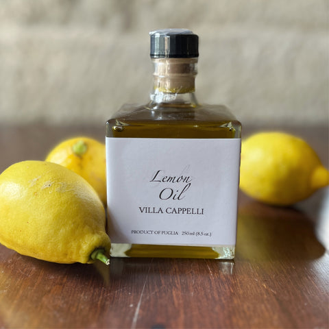 A bottle of Villa Cappelli Lemon Oil sitting on a table.