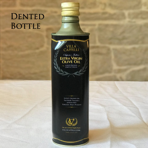 A Villa Cappelli Extra Virgin Olive Oil - 750mL DAMAGED TIN bottle sitting on a table, ready for shipping overseas.