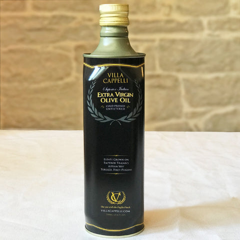 A bottle of Grazie! Thank you! Collection olive oil sitting on a table. (Brand: Villa Cappelli)