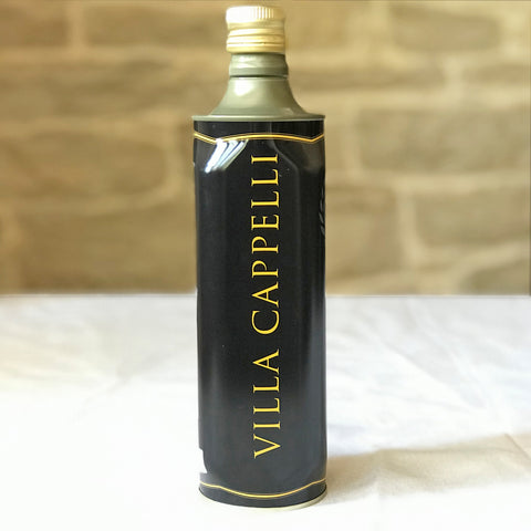 A bottle of Villa Cappelli Extra Virgin Olive Oil - 750mL sitting on a table.