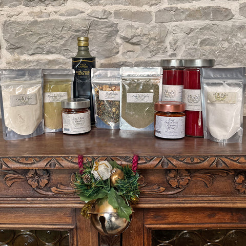 A collection of Villa Cappelli's Delicious Italian Kitchen Collection on a wooden table, accompanied by personalized messages and special instructions.