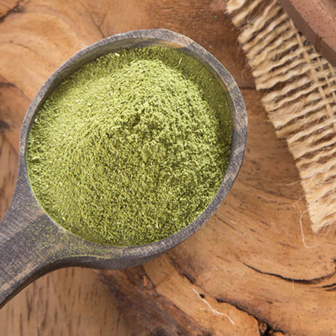 Grazie! Thank you! Collection Matcha powder in a wooden spoon on a wooden table, by Villa Cappelli.