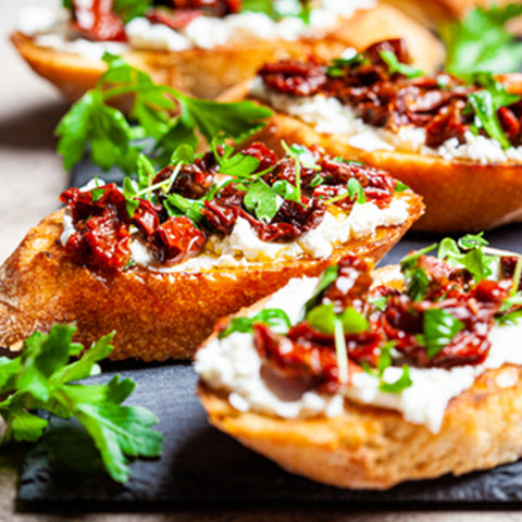Crostini topped with Sun-Dried Tomatoes and parsley by Villa Cappelli.